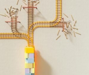 Creative illustration of train tracks on wooden blocks, depicting decision making concepts.